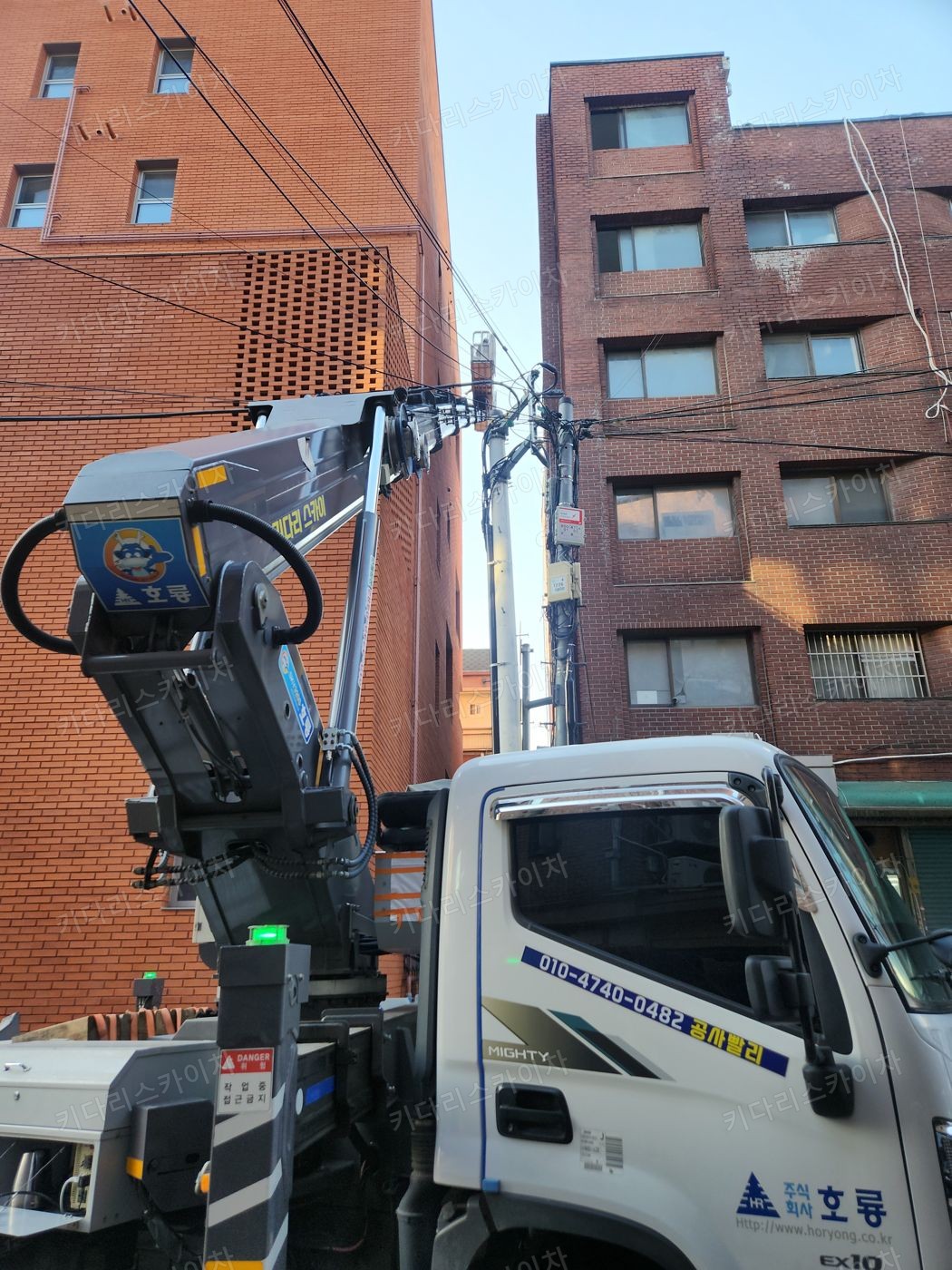 벽돌 건물 앞 스카이차 배치