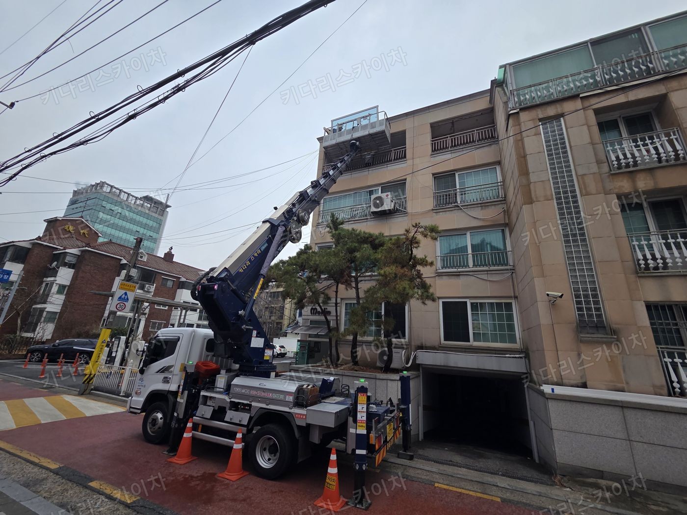 벽돌 건물 앞 스카이차 배치